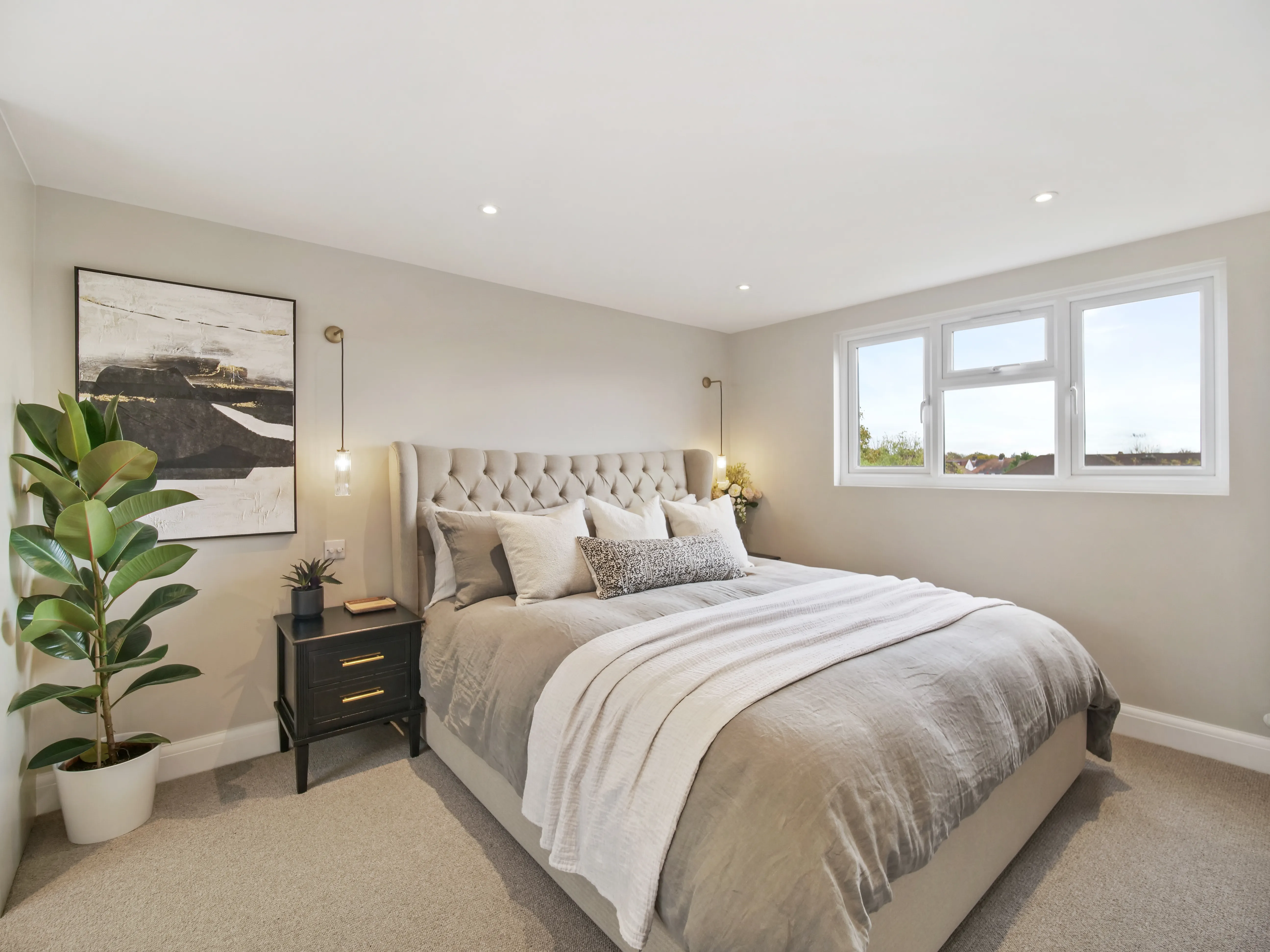 a bedroom with a large bed and a window